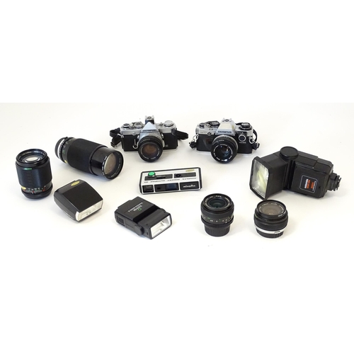 1187 - An Olympus OM10 35mm camera and Olympus OM-1 35mm camera together with a Sunpak Softlite 1600A flash... 