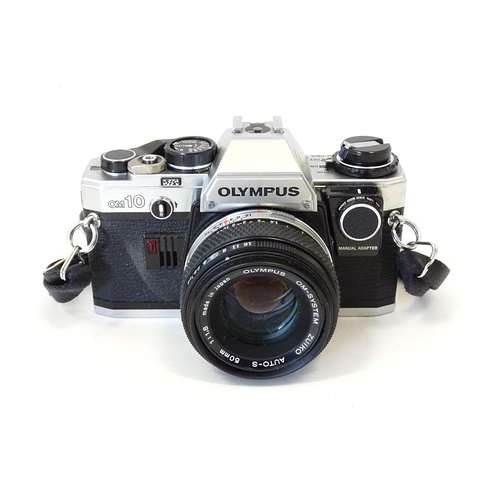 1187 - An Olympus OM10 35mm camera and Olympus OM-1 35mm camera together with a Sunpak Softlite 1600A flash... 