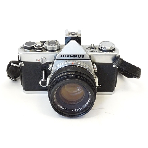 1187 - An Olympus OM10 35mm camera and Olympus OM-1 35mm camera together with a Sunpak Softlite 1600A flash... 