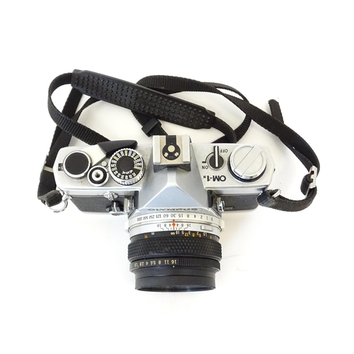 1187 - An Olympus OM10 35mm camera and Olympus OM-1 35mm camera together with a Sunpak Softlite 1600A flash... 