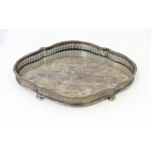 577 - A quantity of silver plated wares to include trays, tea set, bottle coaster, etc.