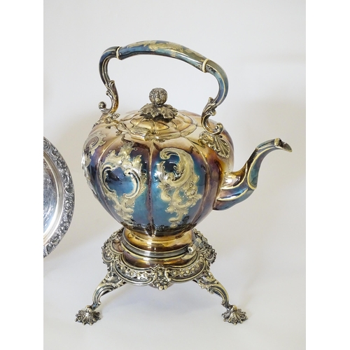 580 - A quantity of 19thC and later silver plated wares to include tea set, spirit kettle, serving dishes,... 