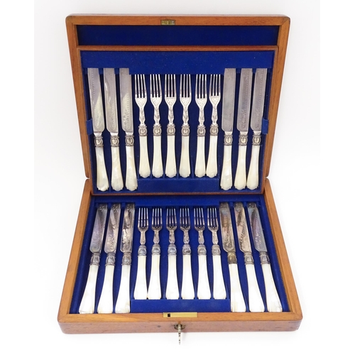 586 - A cased set of six close silver plate fruit knives and forks with mother of pearl handles. 12 1/2