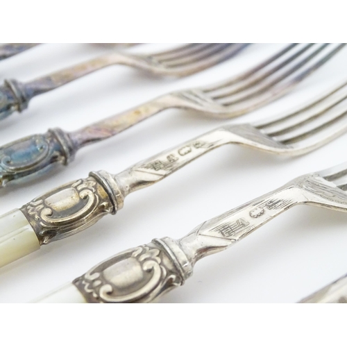 586 - A cased set of six close silver plate fruit knives and forks with mother of pearl handles. 12 1/2