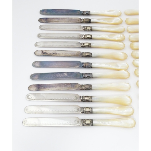 586 - A cased set of six close silver plate fruit knives and forks with mother of pearl handles. 12 1/2