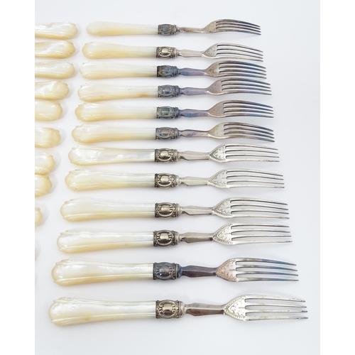 586 - A cased set of six close silver plate fruit knives and forks with mother of pearl handles. 12 1/2