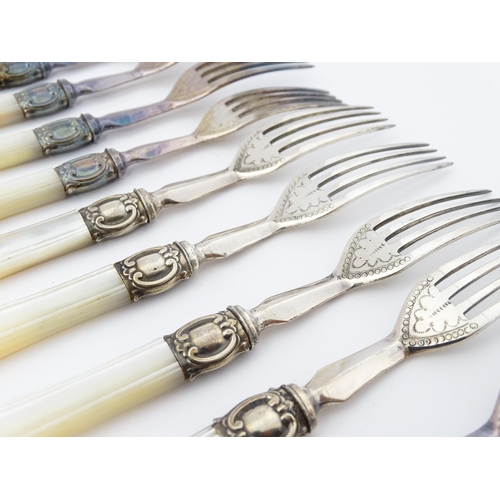 586 - A cased set of six close silver plate fruit knives and forks with mother of pearl handles. 12 1/2