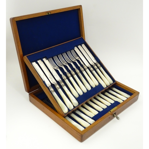 586 - A cased set of six close silver plate fruit knives and forks with mother of pearl handles. 12 1/2