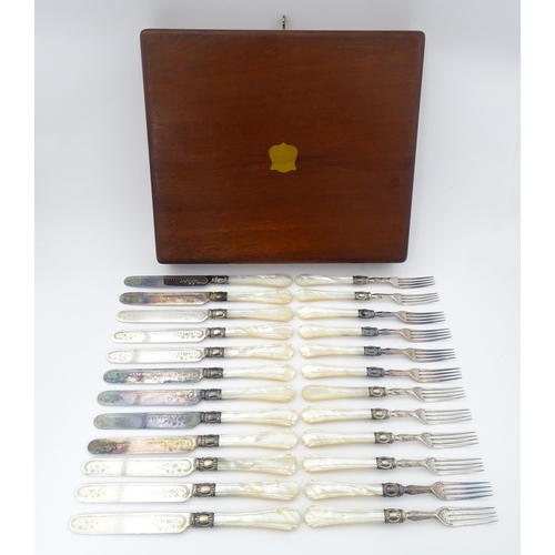 586 - A cased set of six close silver plate fruit knives and forks with mother of pearl handles. 12 1/2