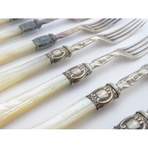 586 - A cased set of six close silver plate fruit knives and forks with mother of pearl handles. 12 1/2