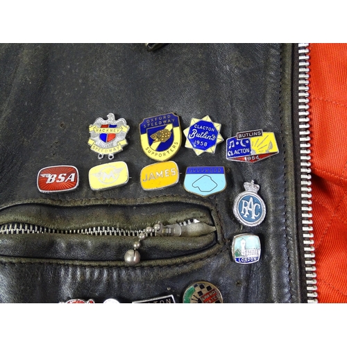 1287 - Vintage fashion / clothing: A vintage black leather biker jacket with a quantity of collectors badge... 