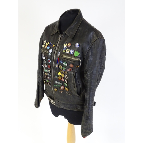 1287 - Vintage fashion / clothing: A vintage black leather biker jacket with a quantity of collectors badge... 