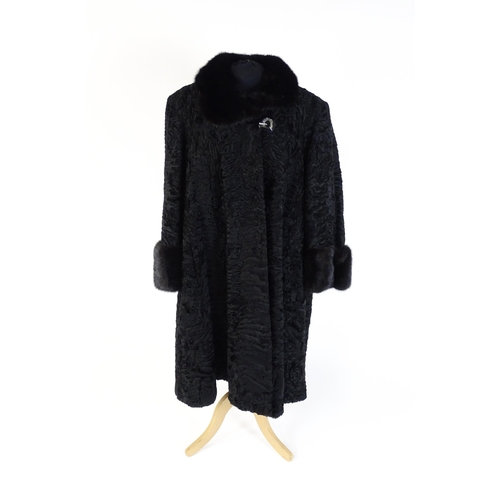 1302 - Vintage fashion / clothing: A black Persian lamb / Astrakhan coat with fur to collar and cuffs. Labe... 