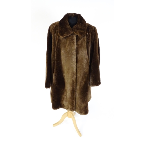 1307 - Vintage fashion / clothing: A mid length brown fur coat. Chest approx. 44