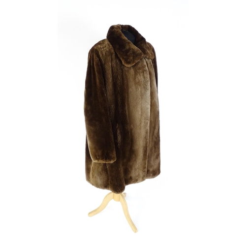 1307 - Vintage fashion / clothing: A mid length brown fur coat. Chest approx. 44