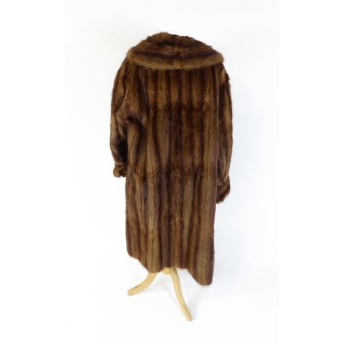 1312 - Vintage fashion / clothing: A mid length fur coat by De Bella. Bust approx. 44