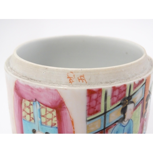 18A - A Chinese / Cantonese famille rose pot and cover depicting figures in an interior. Approx. 4 1/2