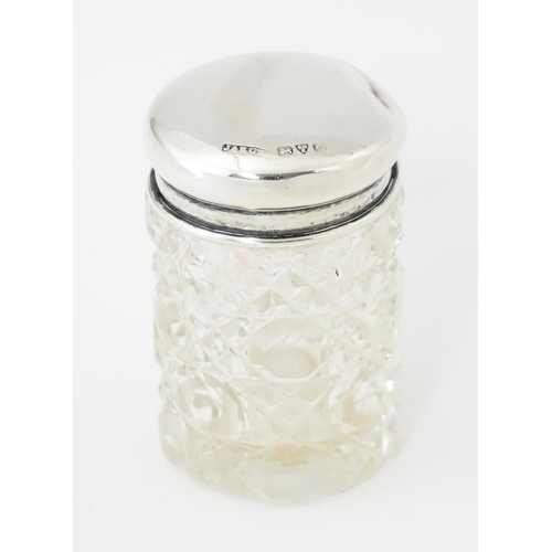 275 - A small cut glass dressing table jar with silver lid hallmarked Chester 1916, maker J & R Griffin Lt... 