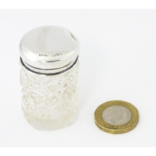 275 - A small cut glass dressing table jar with silver lid hallmarked Chester 1916, maker J & R Griffin Lt... 