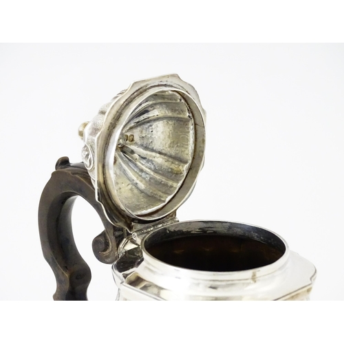 279 - A Victorian silver teapot with engraved decoration and oval figural bust detail. Hallmarked London 1... 