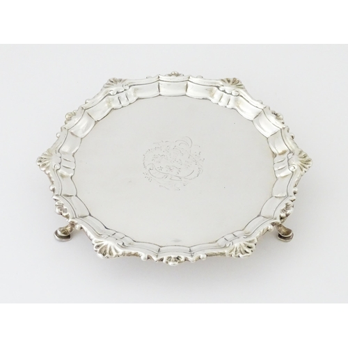 281 - A George II silver waiter with engraved armorial and raised on three feet, Hallmarked London 1745 ma... 