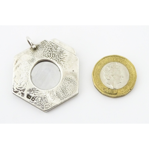 286 - A silver cigar cutter of hexagonal pendant form, hallmarked London 1972, maker Ramsdon and Roed. App... 