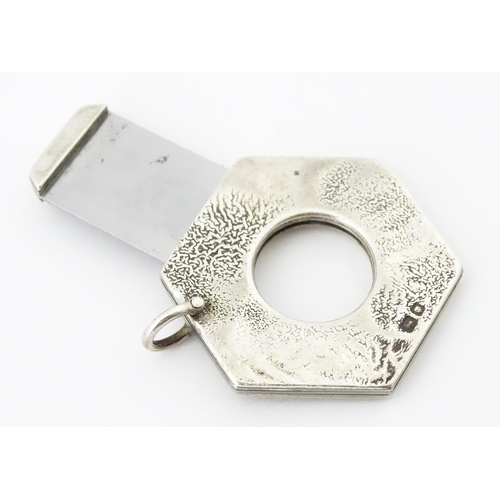 286 - A silver cigar cutter of hexagonal pendant form, hallmarked London 1972, maker Ramsdon and Roed. App... 