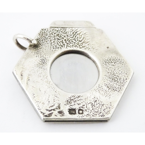 286 - A silver cigar cutter of hexagonal pendant form, hallmarked London 1972, maker Ramsdon and Roed. App... 