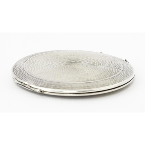 292 - A silver compact with engine turned decoration hallmarked Birmingham 1920, maker W I Broadway & Co. ... 