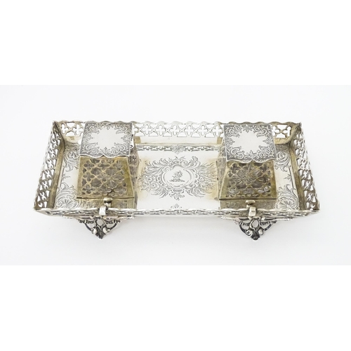 295 - A Victorian silver standish with twin ink bottles, galleried sides and raised on four feet, hallmark... 