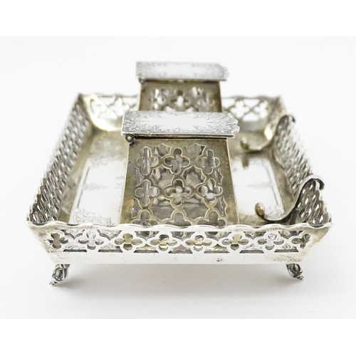 295 - A Victorian silver standish with twin ink bottles, galleried sides and raised on four feet, hallmark... 