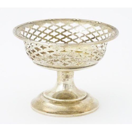 297 - A silver bon bon dish with pierced decoration and pedestal foot, hallmarked Birmingham 1911, maker E... 