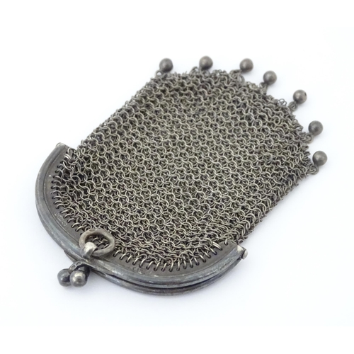 300 - A silver two sectional purse of mesh form bearing import marks for London 1915. Approx. 3 1/4