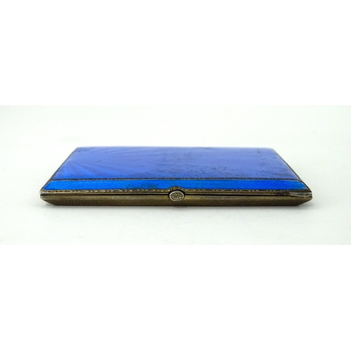 310 - An Art Deco silver cigarette case with blue guilloche enamel decoration and gilded interior, hallmar... 