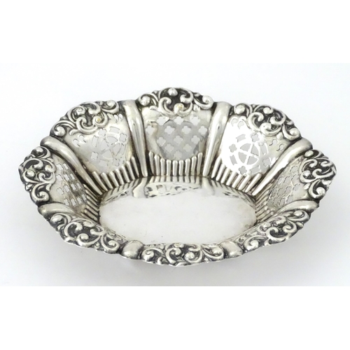 311 - A white metal bon bon dish with pierced and embossed decoration. Approx. 5 1/4