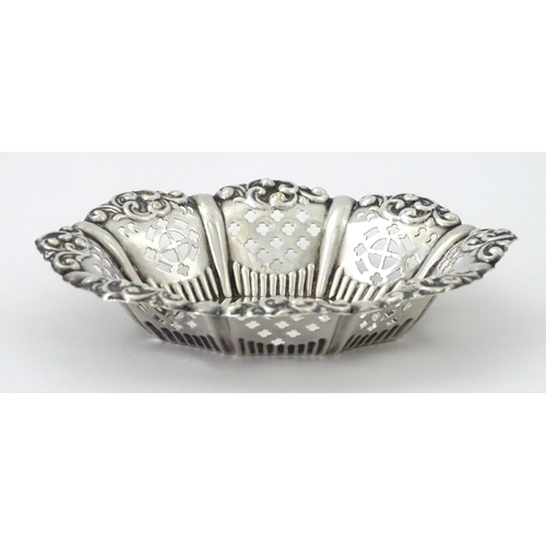 311 - A white metal bon bon dish with pierced and embossed decoration. Approx. 5 1/4