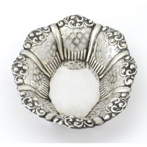 311 - A white metal bon bon dish with pierced and embossed decoration. Approx. 5 1/4