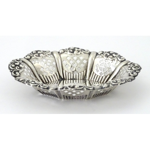 311 - A white metal bon bon dish with pierced and embossed decoration. Approx. 5 1/4