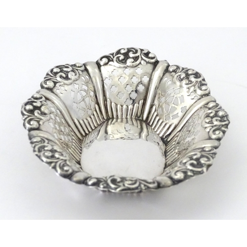 311 - A white metal bon bon dish with pierced and embossed decoration. Approx. 5 1/4