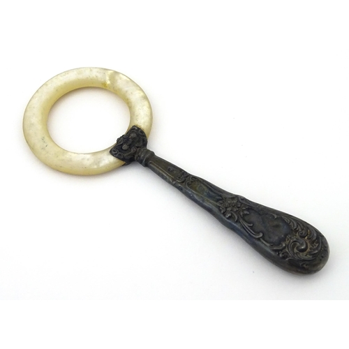 312 - A silver handled mother of pearl teething ring, the handle stamped sterling, with indistinct maker's... 