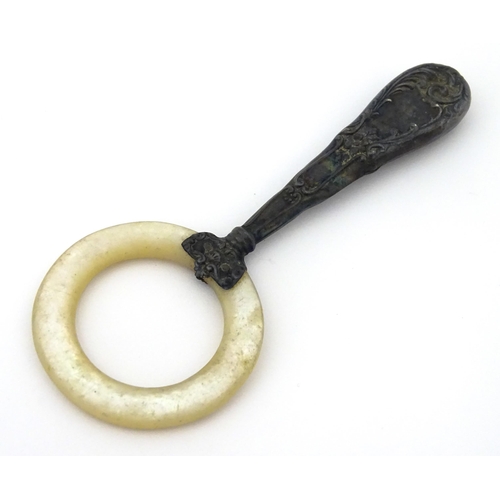 312 - A silver handled mother of pearl teething ring, the handle stamped sterling, with indistinct maker's... 