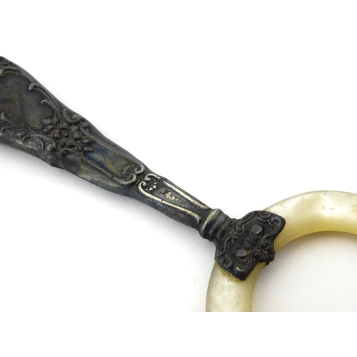 312 - A silver handled mother of pearl teething ring, the handle stamped sterling, with indistinct maker's... 