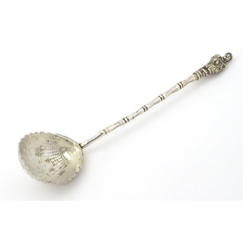 315 - A Chinese Export silver spoon with shell formed bowl and stylised bamboo handle surmounted by an Ori... 