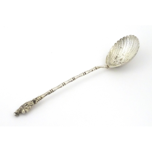 315 - A Chinese Export silver spoon with shell formed bowl and stylised bamboo handle surmounted by an Ori... 