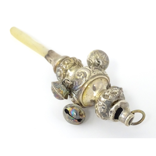 320 - A silver child's rattle with mother of pearl handle, hallmarked Birmingham 1912, maker George Unite.... 