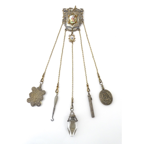 323 - A late 19th / early 20thC silver plate, gilt metal / white metal chatelaine decorated with hand pain... 