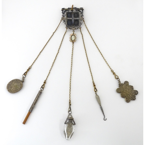 323 - A late 19th / early 20thC silver plate, gilt metal / white metal chatelaine decorated with hand pain... 