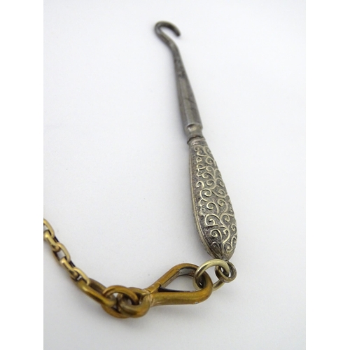 323 - A late 19th / early 20thC silver plate, gilt metal / white metal chatelaine decorated with hand pain... 