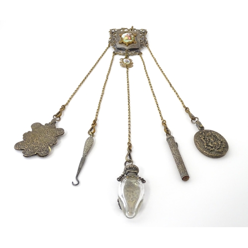 323 - A late 19th / early 20thC silver plate, gilt metal / white metal chatelaine decorated with hand pain... 