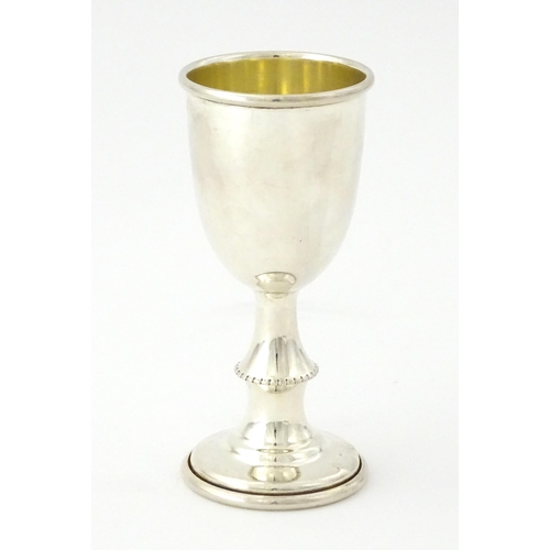 324 - A silver kiddush cup hallmarked Birmingham 1910, maker Jacob Fenigstein. Together with a silver pede... 